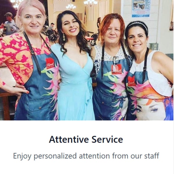 Four smiling women, three in colorful aprons, posing together at Crepe Town European Café & Grill.